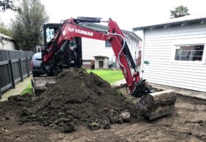 Red Digger with a mound of dirt